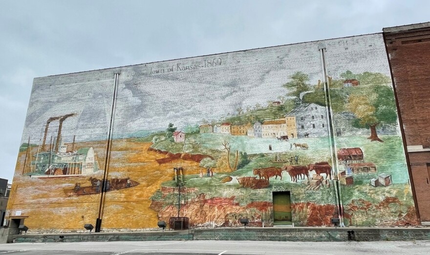 Located at 3rd and Wyandotte in Kansas City, Missouri, the "Town of Kansas 1850" mural was created by Jose Faus, Alisha Gambino and Jesus Ortiz.