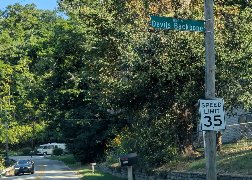a street and street sign reading Devils Backbone