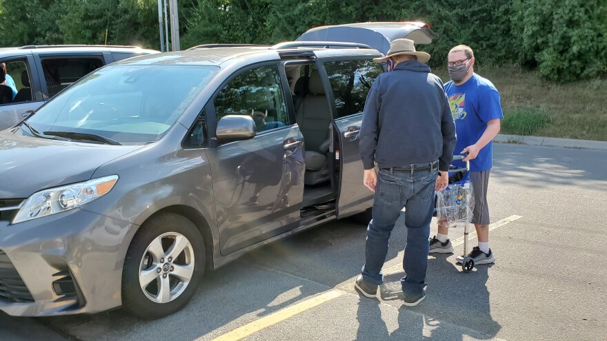 People with disabilities load into vans at the end of the work day at Cottonwood.