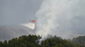 A helicopter conducts bucket drops on the Cienigita Springs Fire on the Mescalero Apache Reservation.
