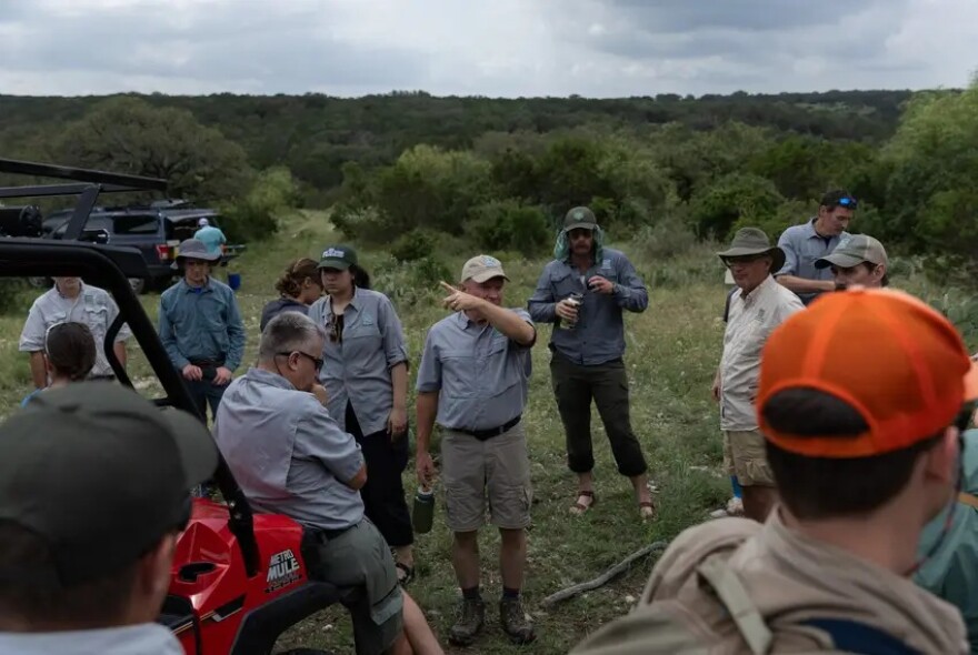 Greg Creacy, the natural resources program director for Texas Parks and Wildlife, delivers instructions for the aquatic sampling search at Yancey Creek, which will be a part of the new Post Oak Ridge State Park.
