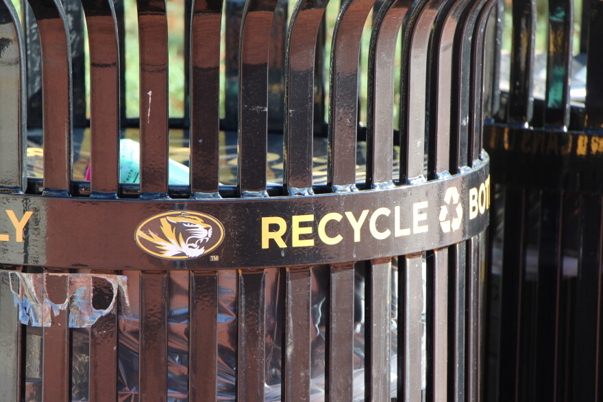 A close up of an MU campus waste can that has the MU tiger logo and the word "Recycle."