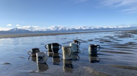 A collection of mugs by participating artists showcases the diversity of creative voices on the tour.