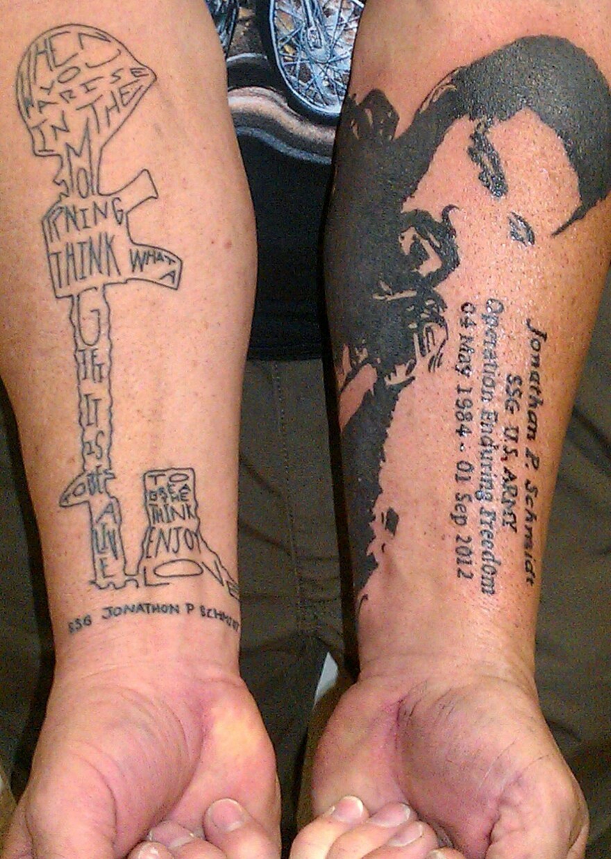Phil Schmidt shows two of the five tattoos he has received to pay tribute to his son Jonathan, who was killed in Afghanistan three years ago.
