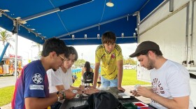 A group of young men gather at Haulover Park in Miami Beach to trade Panini stickers in May 2026 ahead of the World Cup.