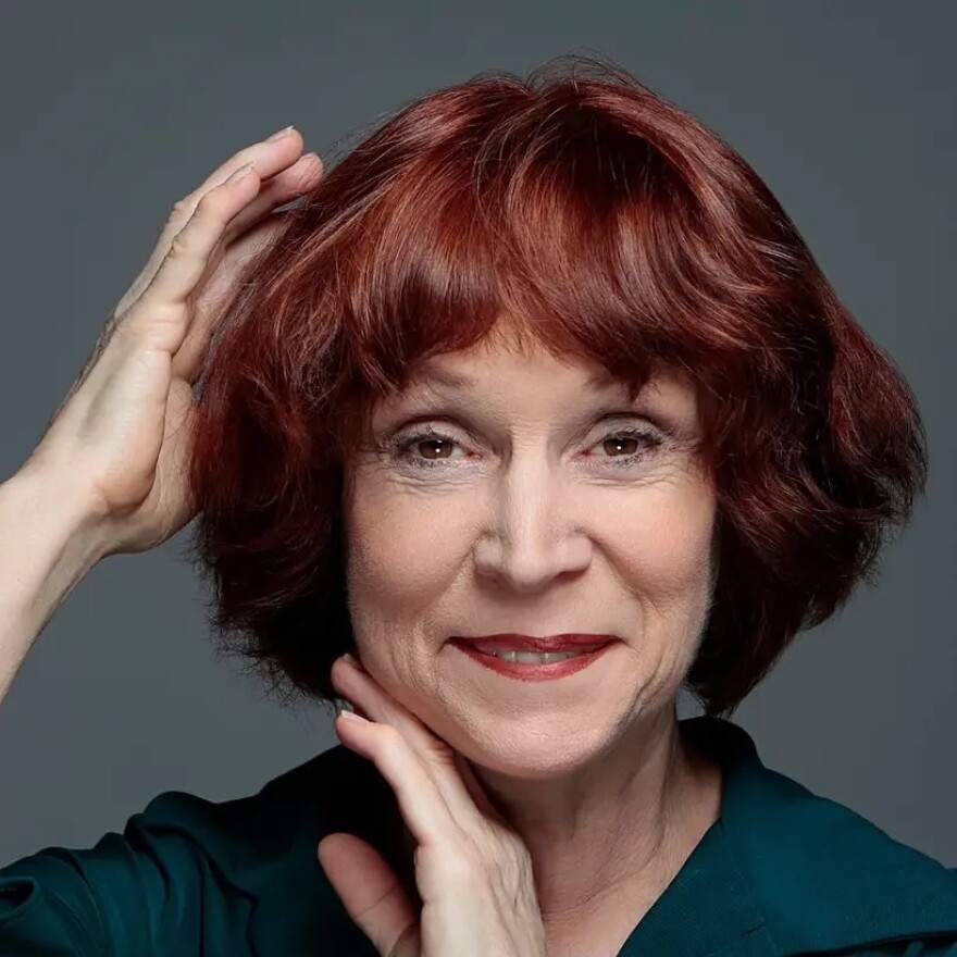 Actress Ann Morrison head shot. Older woman with red hair.