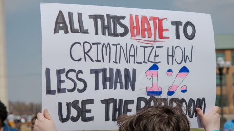 Connor Montgomery, of Manhattan, holds a sign as part of a Trans Day of Visibility demonstration March 31, 2026, outside the Kansas Statehouse.
