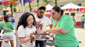 An El Pueblo volunteer helping register a voter at Fiesta del Pueblo, a festival El Pueblo organized in downtown Raleigh on Sept. 20, 2026.