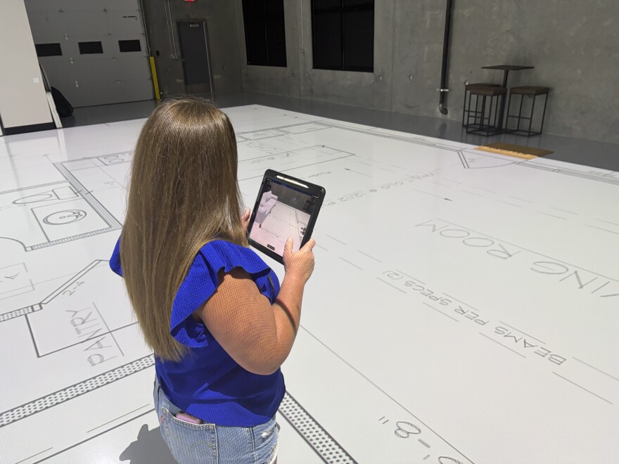Andi Beasley uses augmented reality to place furniture and other details into a projection of her soon-to-be-built new home outside of Rose Hill.