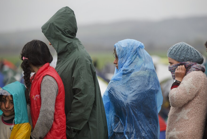 People wait in line for food handouts at the Idomeni camp.