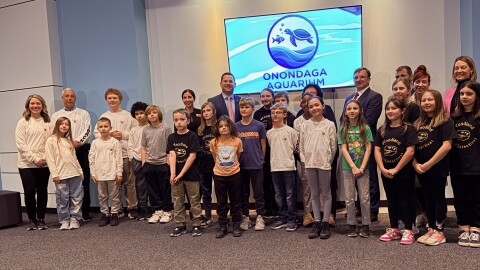 Onondaga County Executive Ryan McMahon and students from the East Syracuse-Minoa school district at an event for the Onondaga County aquarium.