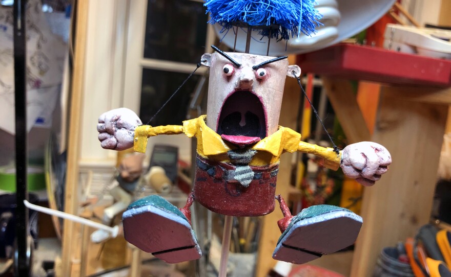 Don Becker's "Angry Man" automaton slowly rises, shakes his fists and blows his wig off when you turn a crank.