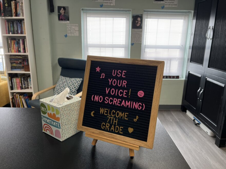 A sign in Mrs. Hall's class, with her posters of civil rights icons in the backdrop.