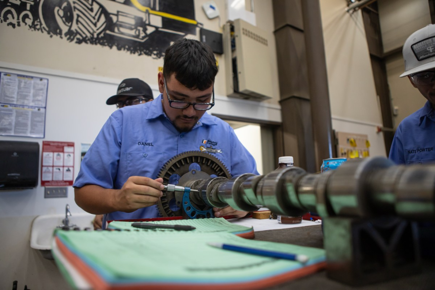 Students measure a part of a tractor engine in their agricultural mechanics class at Reedley College in Reedley on Sept. 11, 2024. Photo by Larry Valenzuela, CalMatters/CatchLight Local
