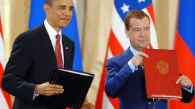 President Obama and his Russian counterpart Dmitry Medvedev hold up their signed copies of the New START documents Thursday at Prague Castle in the Czech capital.