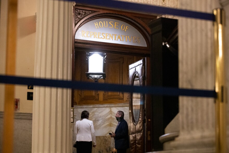 Massachusetts House Judiciary Chair Claire Cronin and Rep. Paul Tucker, a retired police chief, conversed in a chamber entryway. 