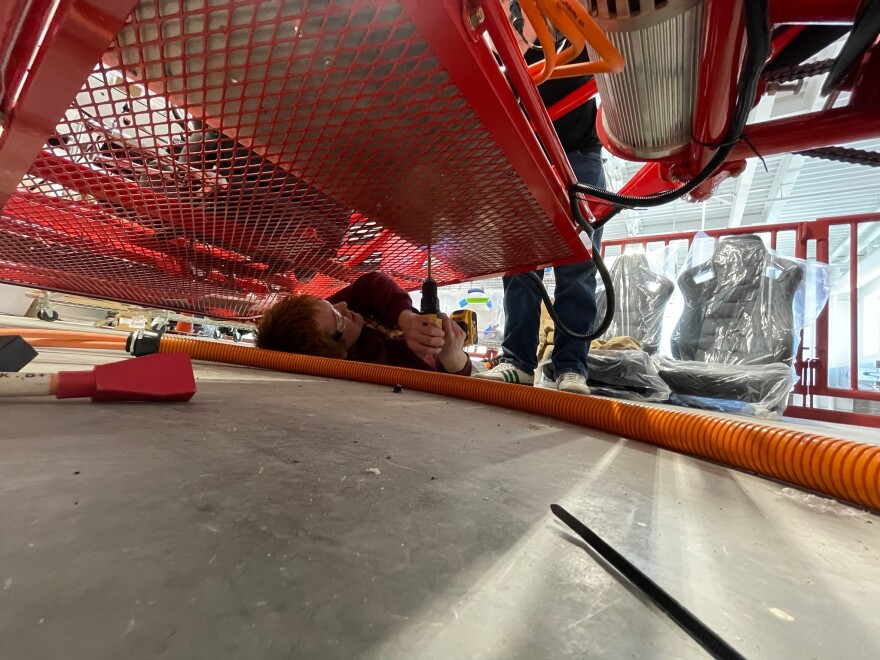 Photo of PCCAPS students working on a homemade electric vehicle. 