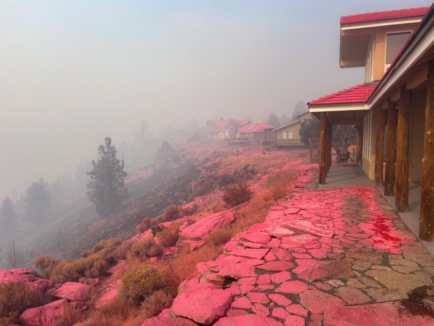 home covered with pink fire retardant
