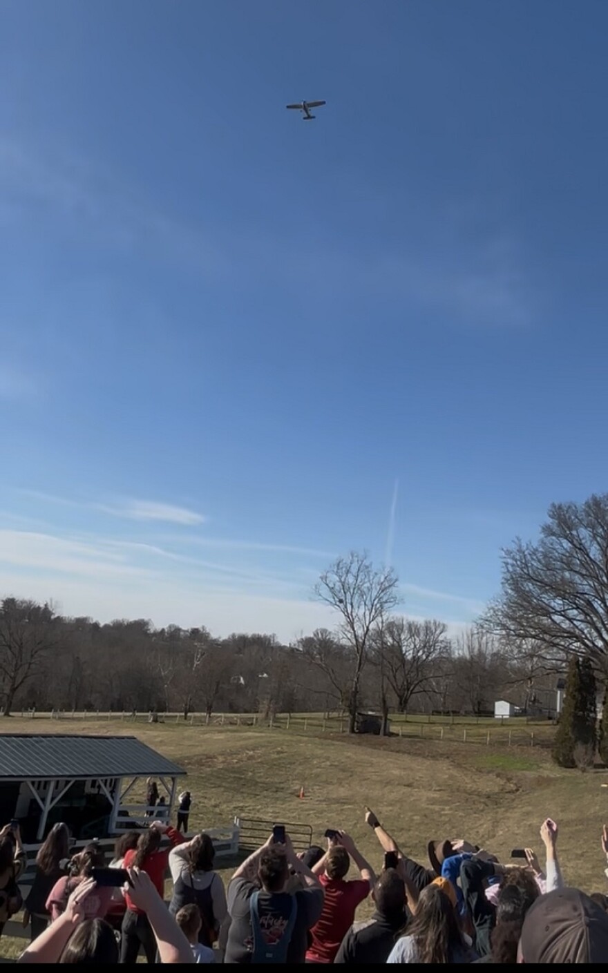 The crowd looks up as 1876 individually wrapped pieces of beef jerky rained down from the window of the airplane.