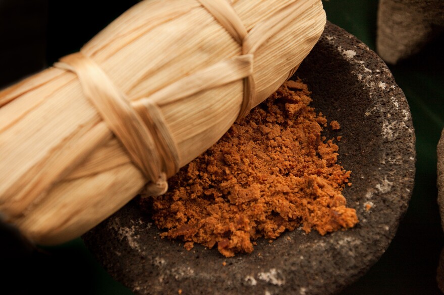 Food: The ancestor's favorite meals are placed on the altar as offerings. Here, Tamale is being served. Tamales are made from corn-based dough, wrapped in cornhusk then steamed. They are filled with a variety of ingredients like shredded chicken in a green spicy sauce or sweetened with pineapple-cinnamon jellies