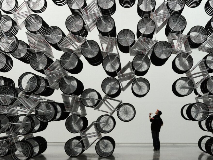 A man admires <em>Forever Bicycles</em>, a work by Ai Weiwei, at the Taipei Fine Art Museum last month.