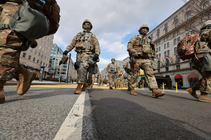 Members of the National Guard walking through Black Lives Matter Plaza to switch shifts with other members after President Biden inauguration ceremony ended in Washington D.C.