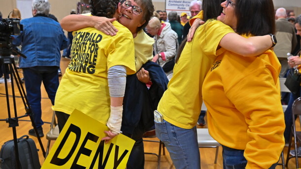Members of the Archbald community hug each other after borough council denied a data center campus developer's zoning application.