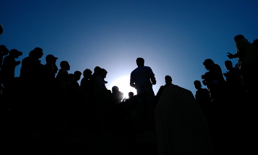 <strong>May 12, 2012:</strong> <em>Barzah, Damascus</em> — Mourners gather in a cemetery to pray for those killed in protests against the Syrian government.