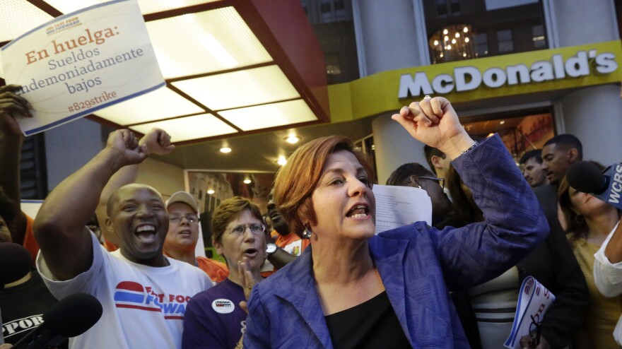 New York City Council speaker and then-mayoral candidate Christine Quinn speaks at a fast-food workers' protest outside a McDonald's in New York in August. A nationwide movement is calling for raising the minimum hourly wage for fast-food workers to $15.