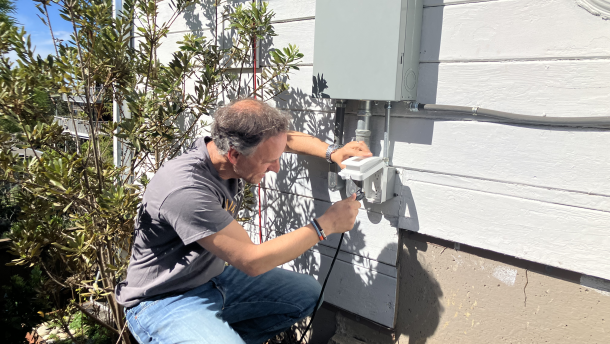 Rupert Mayer plugs his solar panels into a dedicated outlet at his Berkeley home.