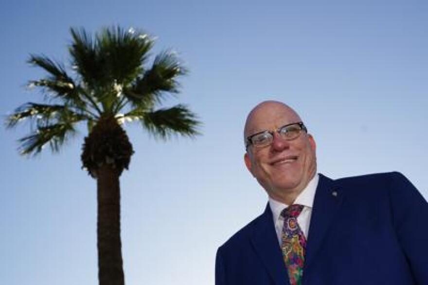 R. Glenn Williamson, Canada's Arizona honorary consul and founder and CEO of the Canada Arizona Business Council, soaks up the morning sun at the Arizona Biltmore resort Wednesday, Oct. 27, 2021, in Phoenix. Williamson says he's looking forward to the return of Canadian snowbirds to the state now that vaccinated people from other countries can enter the U.S. by land starting Nov. 8.