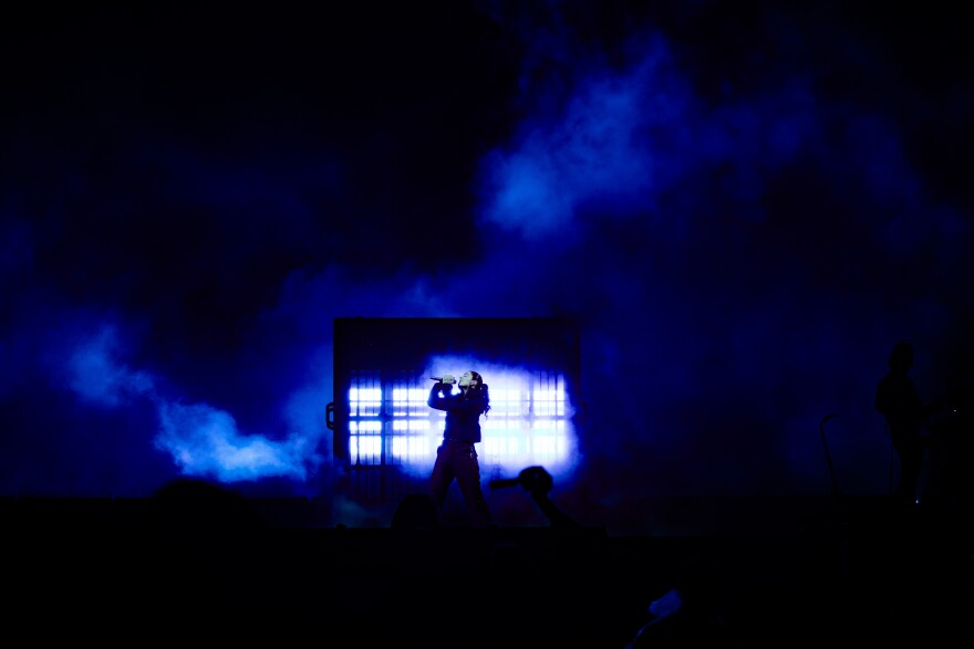 a woman on stage singing 