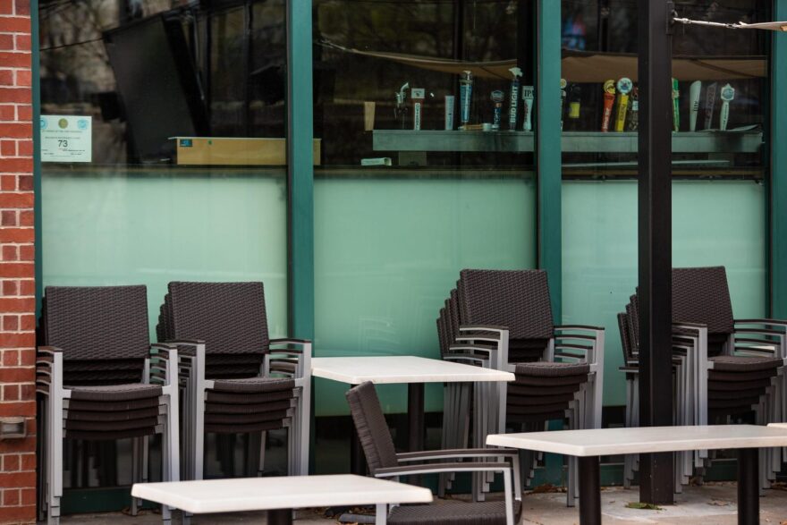 Patio chairs are stacked in front of an Oklahoma City bar on March 24. The city closed bars in an effort to slow the spread of the coronavirus.