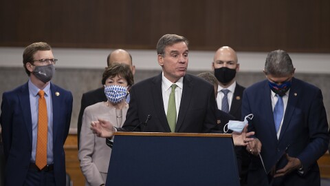 Sen. Mark Warner speaks alongside a bipartisan group of lawmakers as they announce a proposal for a $908 billion coronavirus relief bill on Tuesday.