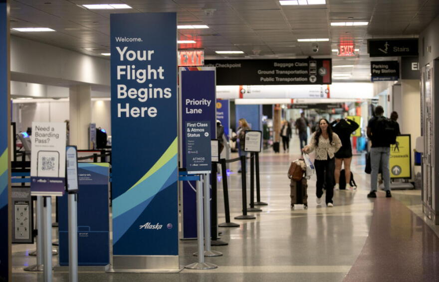 Passengers walk to their check-in desks at Boston's Logan Airport, Terminal B.  (Robin Lubbock/WBUR)