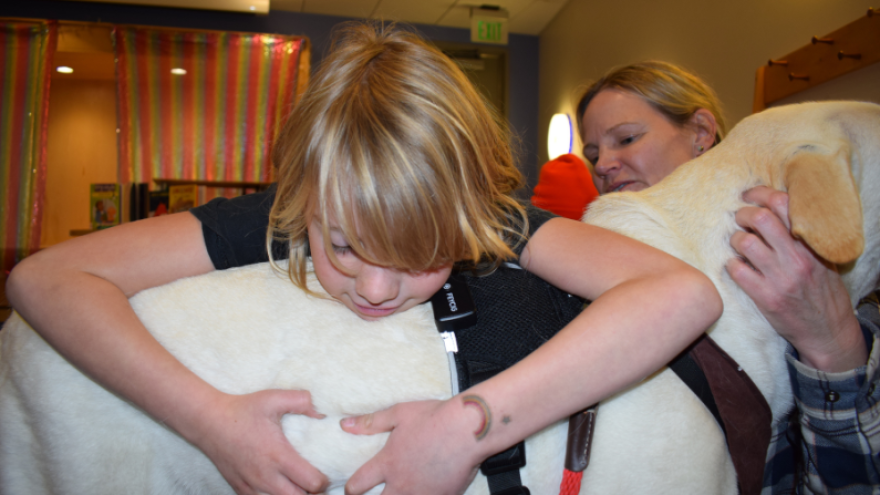 Seven-year-old Ezra Koerber has become fast friends with seven-year-old Flash. Britt Baker, Flash’s owner, watched the two crawl around with each other on all fours during the “Ruff Readers” program at the Teton County Library on Nov. 18.