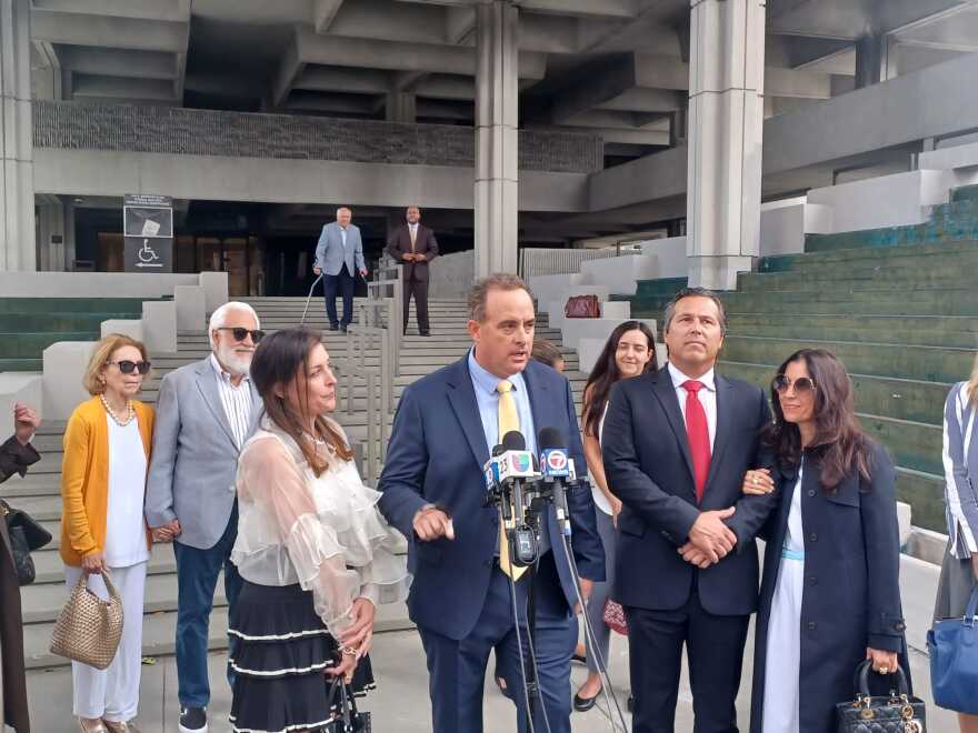 Plaintiffs William Fuller and Martin Pinilla with their families outside the federal courthouse in Fort Lauderdale on June 1, 2023 following the verdict in their civil trial against Joe Carollo.