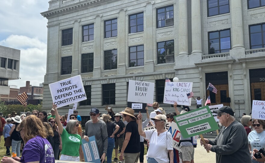  A photo of people marching through downtown Greensboro 