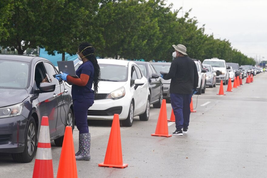 Motorists line up for drive-through COVID tests near Miami this week. Rep. Dina Titus, a Democrat from Las Vegas, says "we need to up our supplies for testing" as omicron variant infections spike.