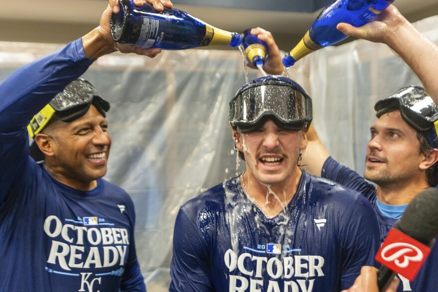 Kansas City Royals shortstop Bobby Witt Jr., center has champagne poured on him by teammates during the celebration in the locker room after a baseball game against the Atlanta Braves, Friday, Sept. 27, 2024, in Atlanta.