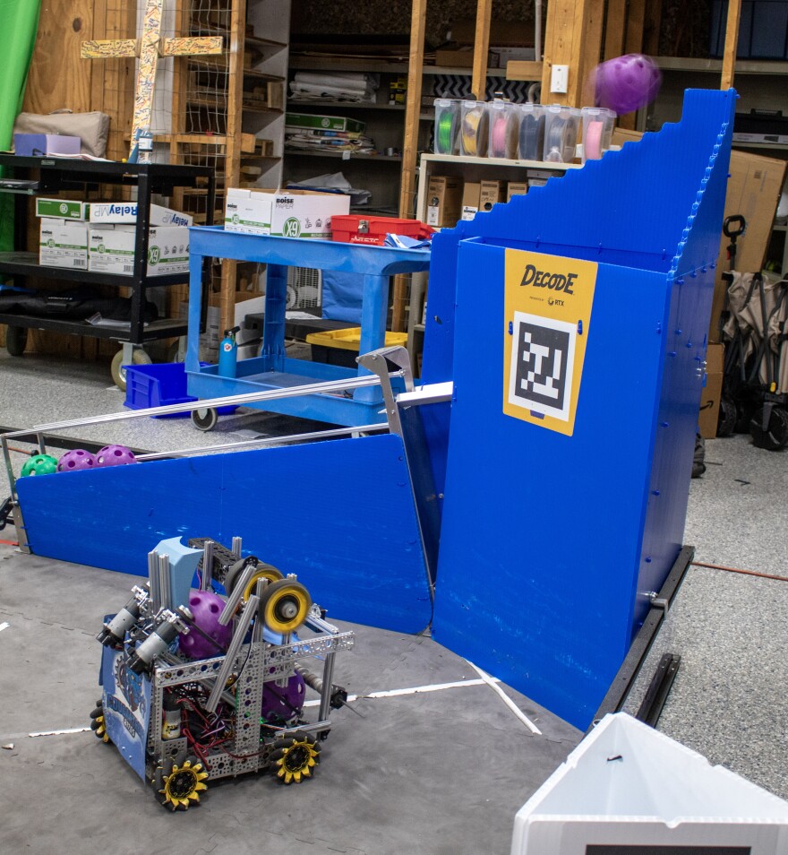 The Cougartrons' robot makes a shot into the basket during a Tuesday morning practice. In this year's challenge, described as "robot basketball", teams earn points based on how many baskets its robot can make during an allotted time.