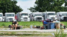 A man sits alongside his belongings on June 10 near NW 2 and Lincoln Blvd in Oklahoma City.