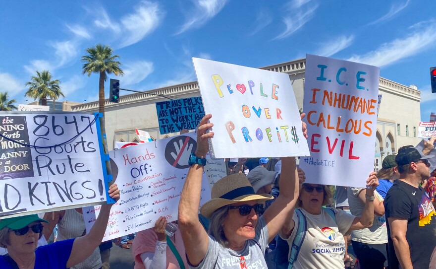 Demonstrators at the Arizona Capitol protesting and marching against actions taken by the Trump administration on May 1, 2025.