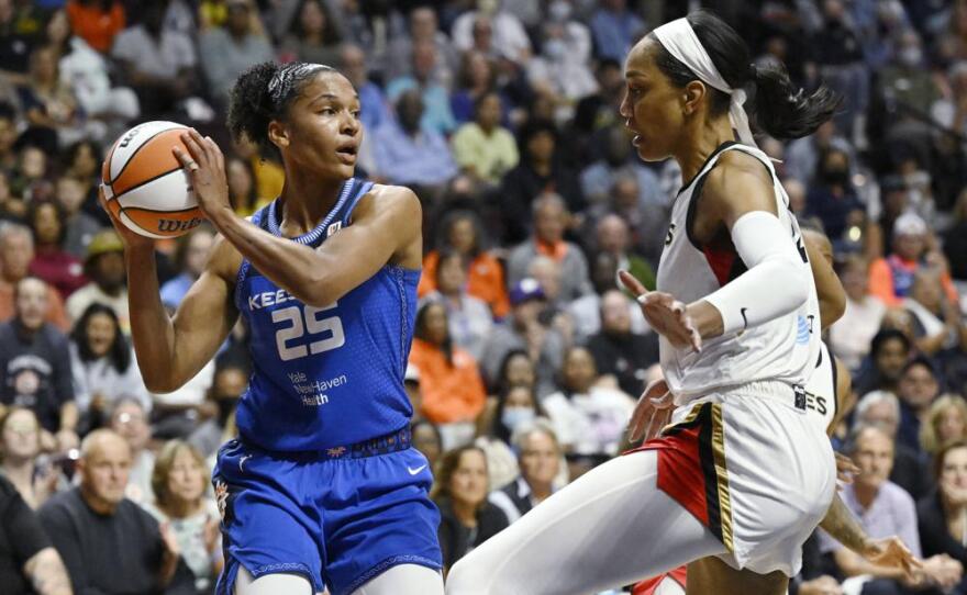 The Connecticut Sun's Alyssa Thomas (left) looks to pass while the Las Vegas Aces' A'ja Wilson defends during the first half in Game 3 of a WNBA basketball Finals, Thursday, Sept. 15, 2022, in Uncasville, Conn.