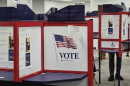 Polling booths with "vote" signs 