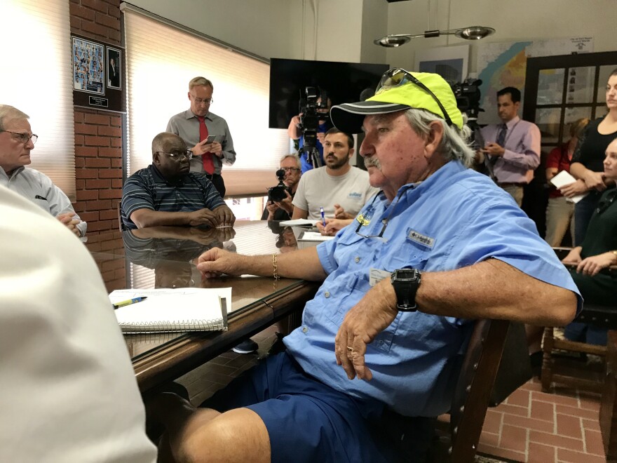 Billy Kirkland of Sanibel listens as US Senator Bill Nelson talks about algae causes and solutions