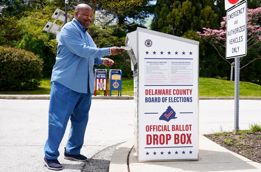 A voter drops off his mail ballot for the 2022 Pennsylvania primary elections in Newtown Square, Pa., on May 2. The state's Supreme Court has ruled in a lawsuit challenging the constitutionality of a state law that expanded mail-in voting.