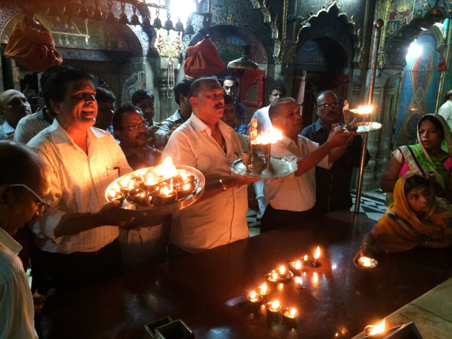 On Friday nights in their Delhi sanctuary, Jains light candles to pay tribute to their 24 gods.