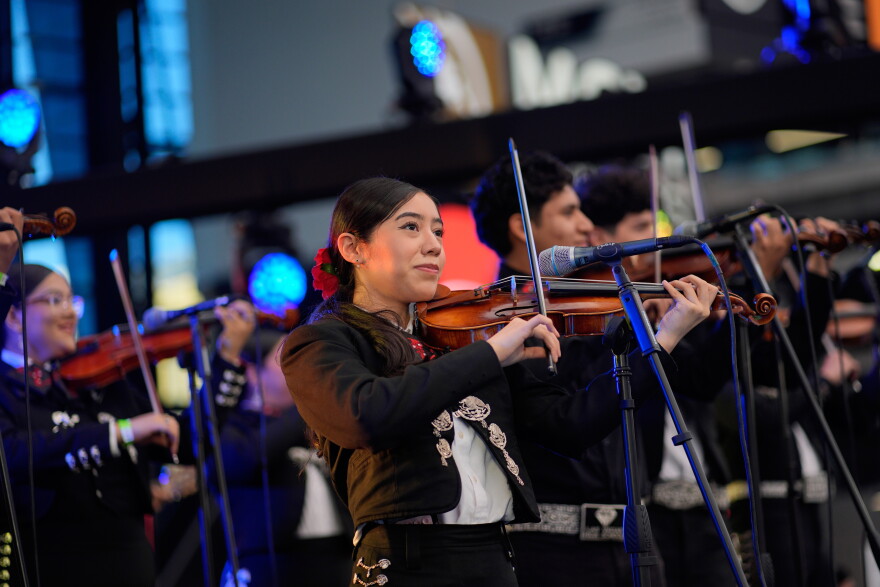 Brenda Guzman performs with other University of Nevada, Las Vegas mariachi students at a football game Saturday, Oct. 3, 2026, in Las Vegas. (AP Photo/John Locher)