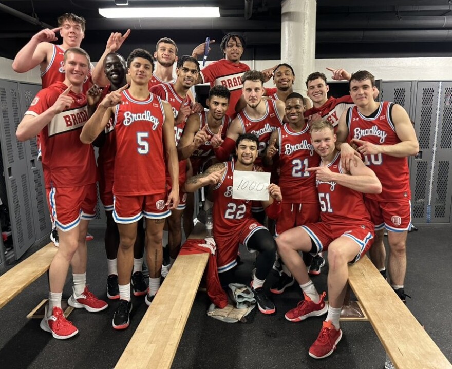 The Bradley men's basketball team celebrates fifth-year senior Ja'Shon Henry (22) reaching 1,000 career points in the Braves' 76-66 road win over Valparaiso on Wednesday night.